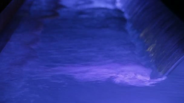 Violet light waterfall. A small waterfall and a torrent of water. Violet light water. — Stock Video