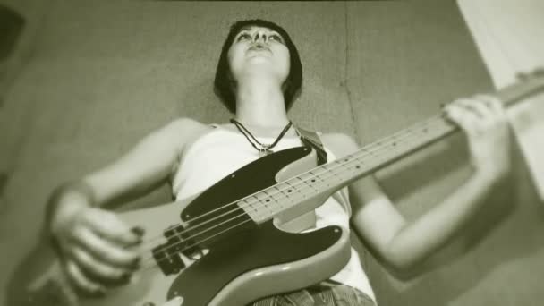 Gitarr i händerna på en kvinnlig gitarrist aktivt spela gitarr. gamla filmer. — Stockvideo