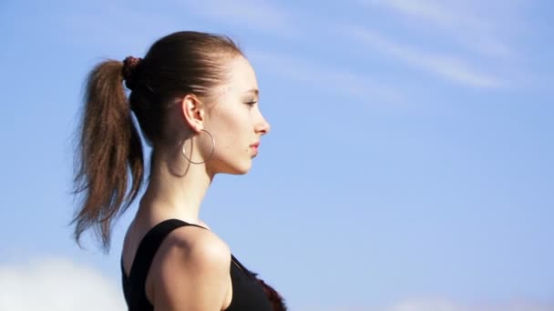 Woman in the mountains. Beautiful girl fashion model sitting on a rock against the beautiful natural scenery. Two frame. Close-up. — Stock Video