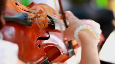 kemancı keman çalıyor. Kız profesyonel bir orkestrada keman oynandı. iki kare. arka plan bulanık.