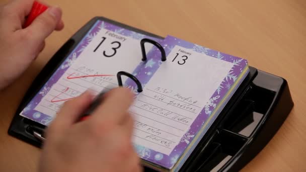 Marking a Valentine day in a calendar — Stock Video