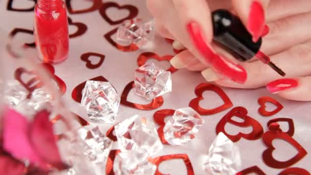 Meisje schildert haar nagels. een vrouw die zich klaar voor de dag van Valentijnskaarten. — Stockvideo