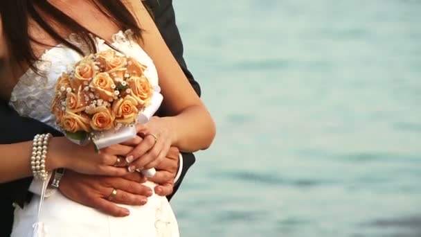 Nevěsta a ženich drží svatební kytici