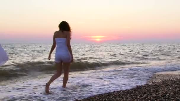 Women spending time near the sea at sunset — Stock Video