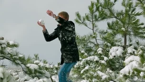 Casal jogando bolas de neve na floresta de pinheiros — Vídeo de Stock