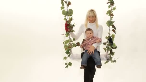 Mother swinging with her little child. On a swing. — Stock Video