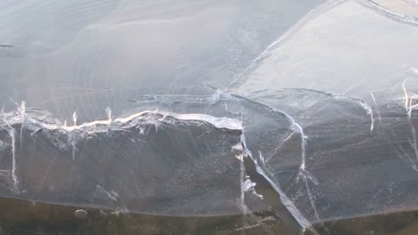 Risse an der Oberfläche eines zugefrorenen Sees. Risse im Eis. — Stockvideo