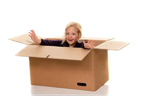 Child in moving box. if moving to box. — Stock Photo, Image
