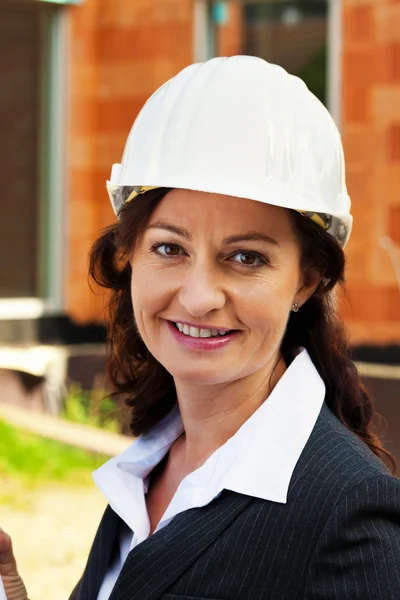 Architect with blueprint at construction site — Stock Photo, Image