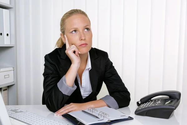 Pensive business woman in office — Stock Photo, Image