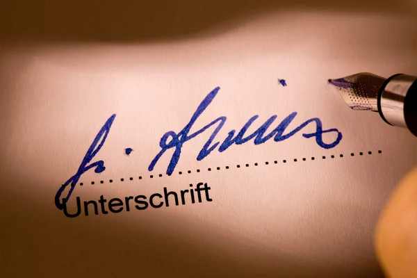 Fountain pen signature on a letter — Stock Photo, Image
