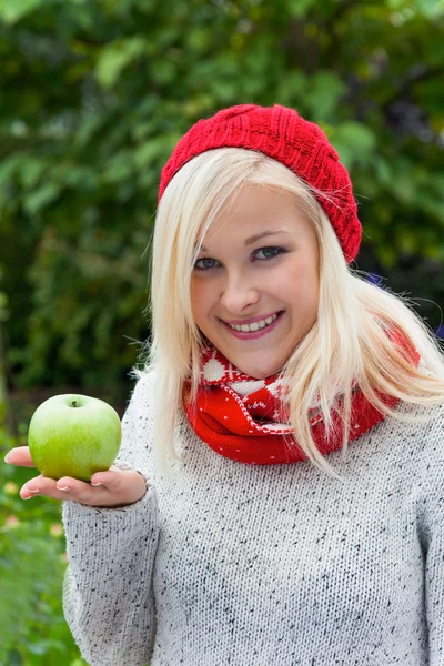 Woman with apple. vitamins in autumn — Stock Photo, Image