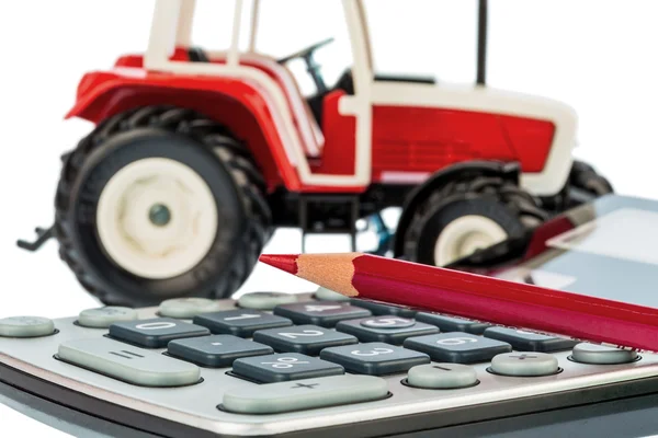 Tractor, red pencil and calculator — Stock Photo, Image