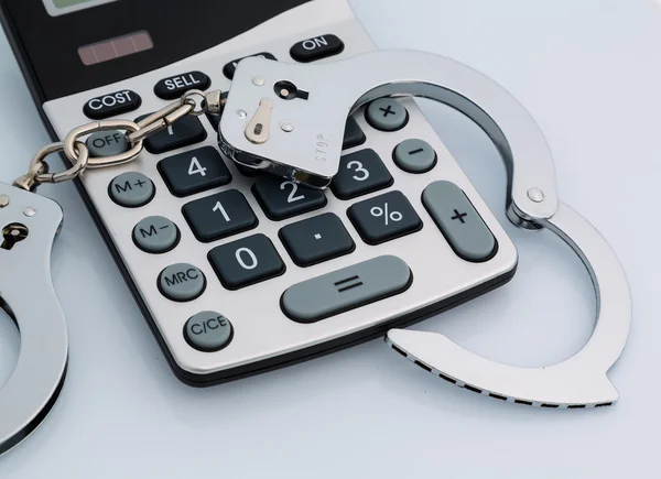 Calculators and handcuffs — Stock Photo, Image