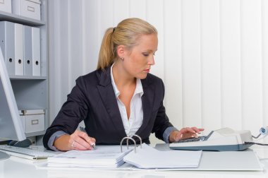 Woman in office with calculator clipart