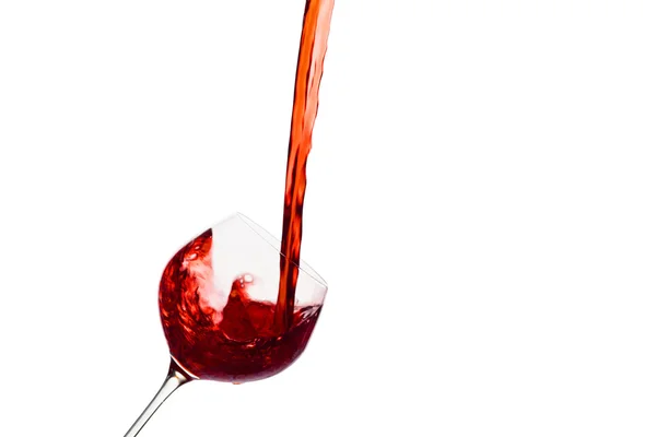 Red wine being poured into a wine glass — Stock Photo, Image