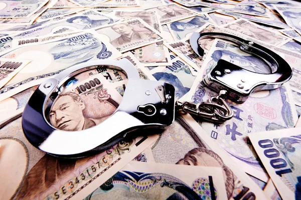 Notas de ienes, moeda do Japão e algemas — Fotografia de Stock