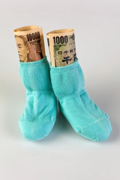 Children socks with japanese yen bank notes — Stock Photo, Image