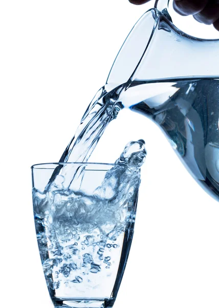 Glass with water and jug — Stock Photo, Image