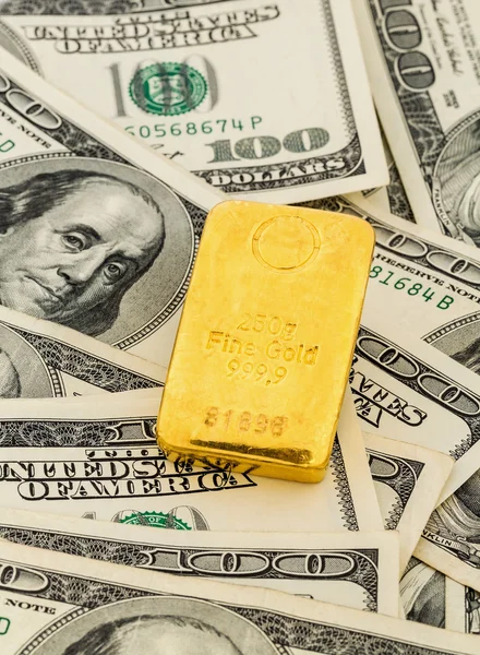 Gold bars on dollar bills — Stock Photo, Image