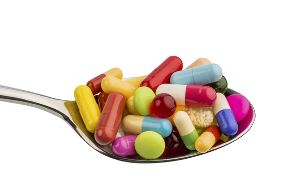 Many tablets on spoon — Stock Photo, Image