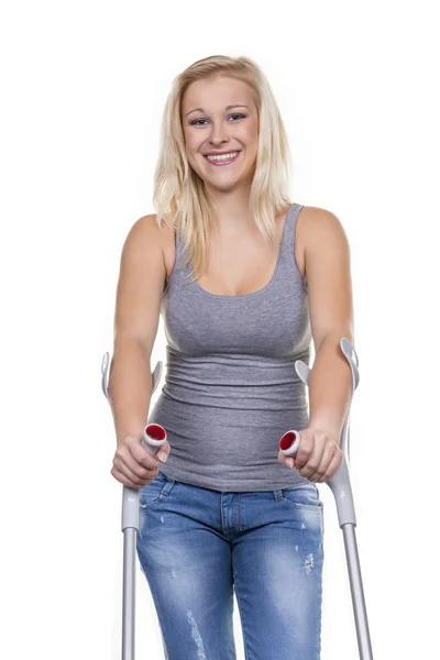 Woman with crutches — Stock Photo, Image