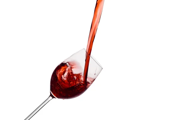 Red wine being poured into a wine glass — Stock Photo, Image