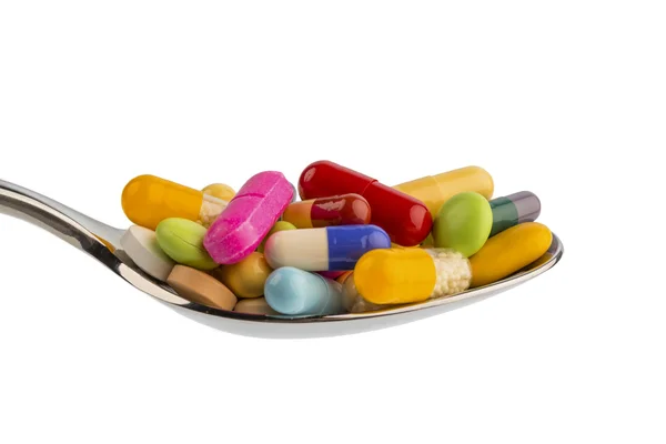 Muitos comprimidos na colher — Fotografia de Stock