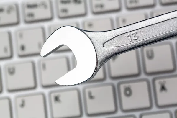 Tool on computer keyboard — Stock Photo, Image