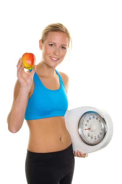 Mujer con manzana y escamas — Foto de Stock