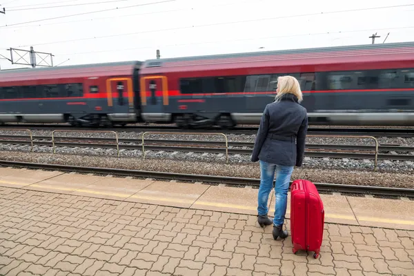 Vrouw te wachten voor de treinstation op hun — Stockfoto