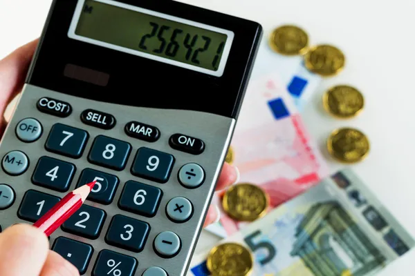 Hand with calculator and money — Stock Photo, Image