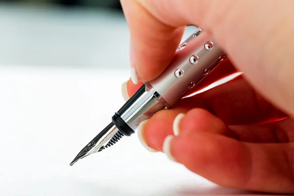 Hand with fountain pen with signature — Stock Photo, Image