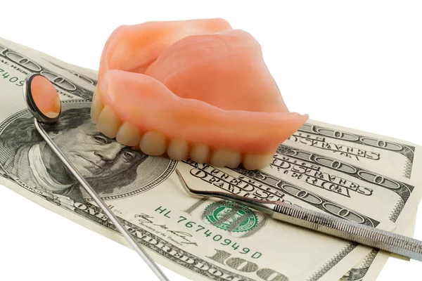 Zubní protézy a dolarové bankovky — Stock fotografie
