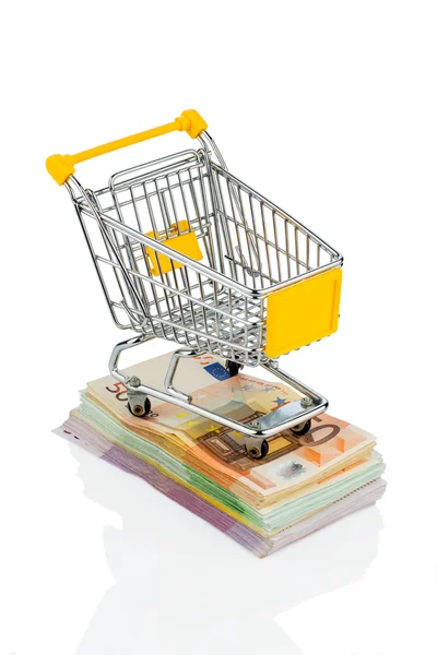 Shopping cart on bills — Stock Photo, Image