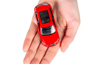 Hand holding model of a car clipart