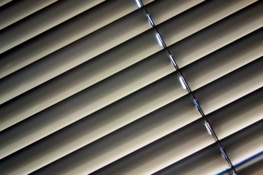 Venetian blinds for shade at the window clipart