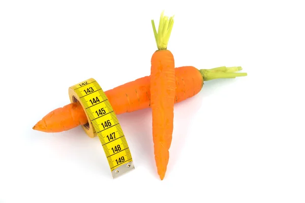 Fresh carrots with tape measure — Stock Photo, Image