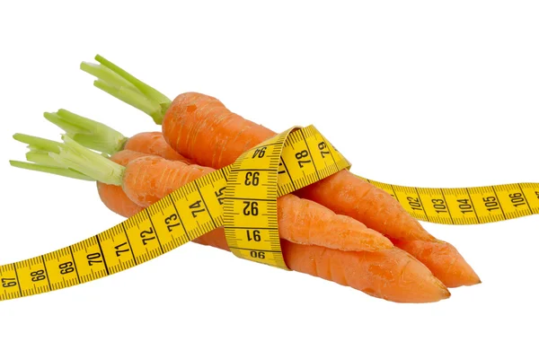 Fresh carrots with tape measure — Stock Photo, Image