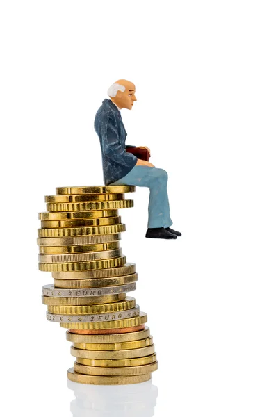 Pensioners sitting on a pile of money — Stock Photo, Image