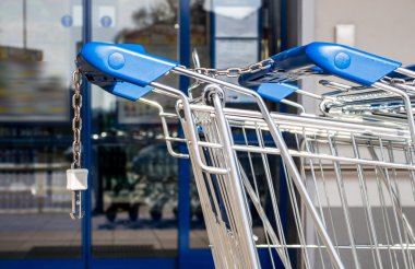 Shopping cart in front of a supermarket clipart