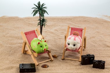 Piggy bank in a deck chair clipart