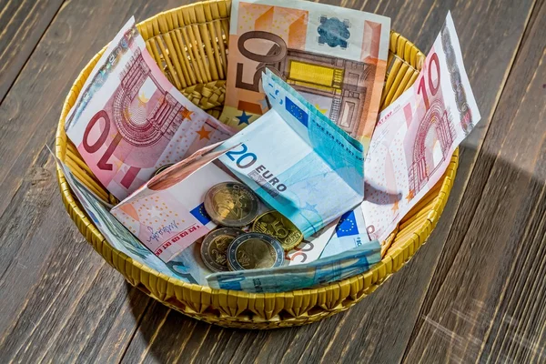 Basket with money from donations — Stock Photo, Image