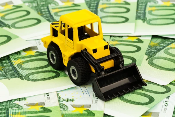 Excavator on euro banknotes — Stock Photo, Image