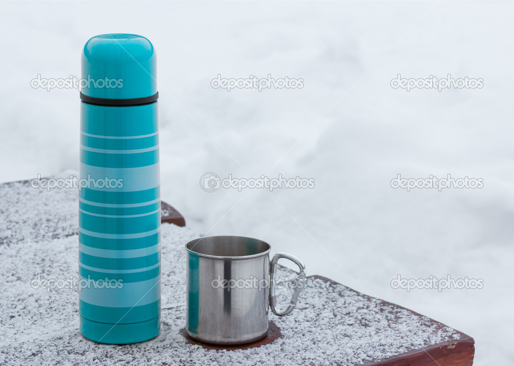 Blue thermos and tourist mug