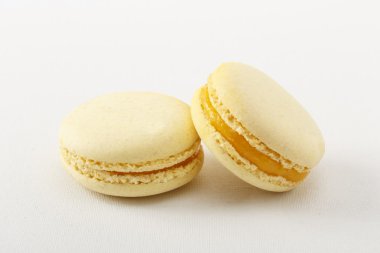 beyaz zemin üzerine sarı acıbadem kurabiyesi