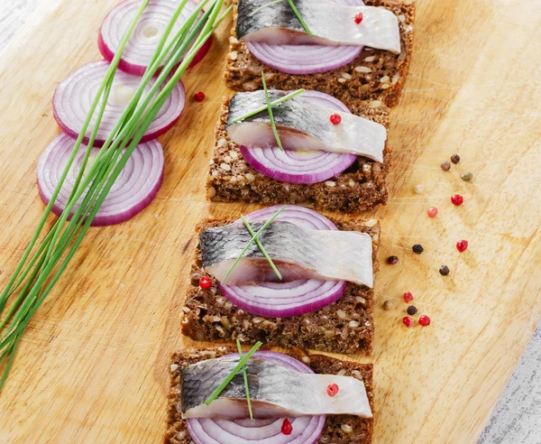 Piece of herring on a slice bread — Stock Photo, Image