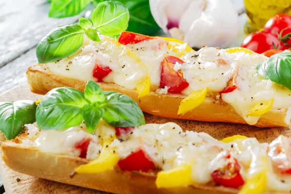 Bruschetta with tomatoes and bell peppers mozzarella — Stock Photo, Image