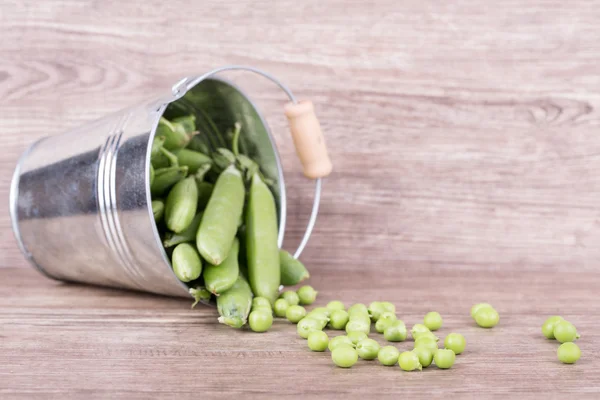Peas in a bucket — Stock Photo, Image