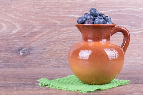 Blueberries in a clay jug — Stock Photo, Image